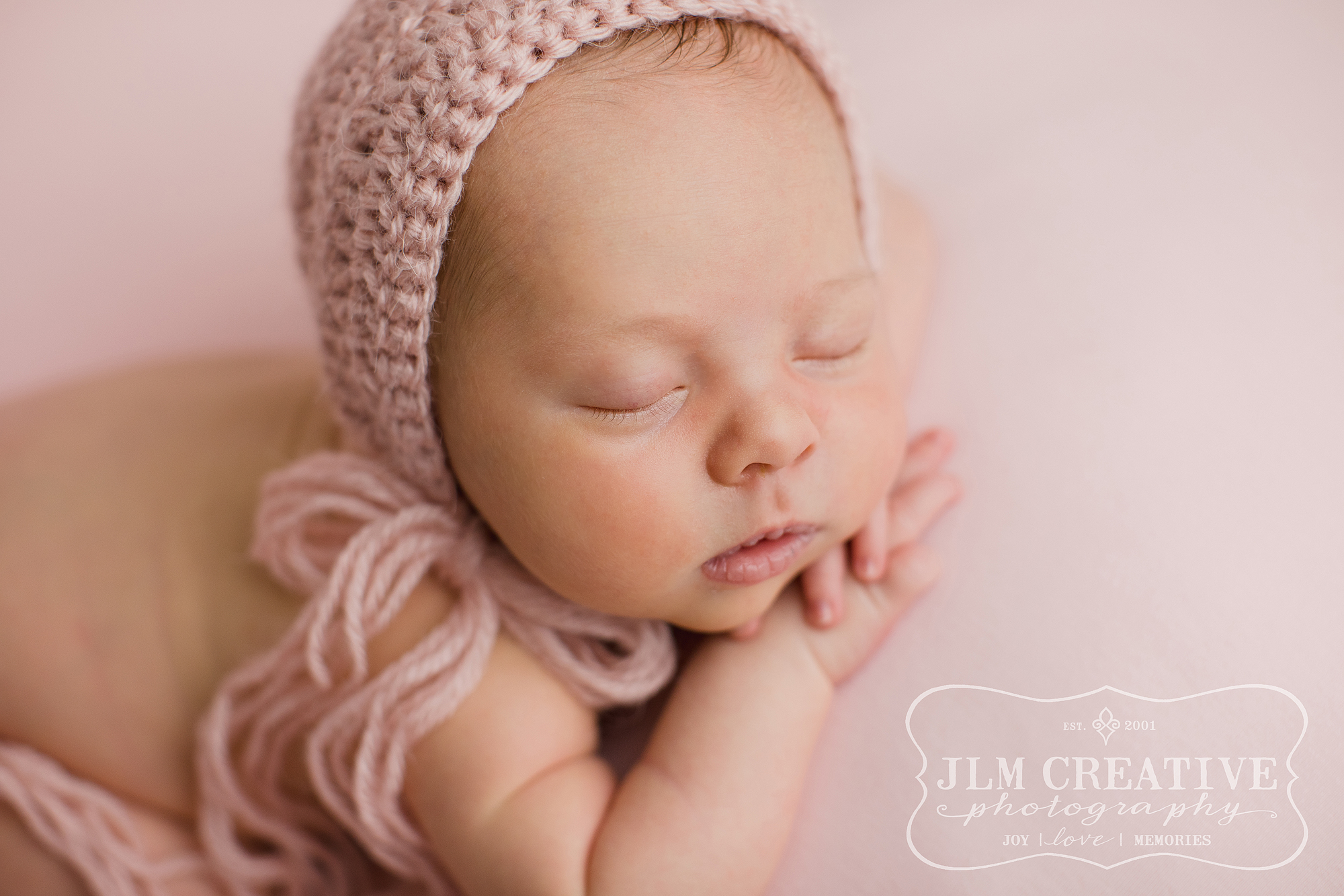 baby girl with pink bonnet
