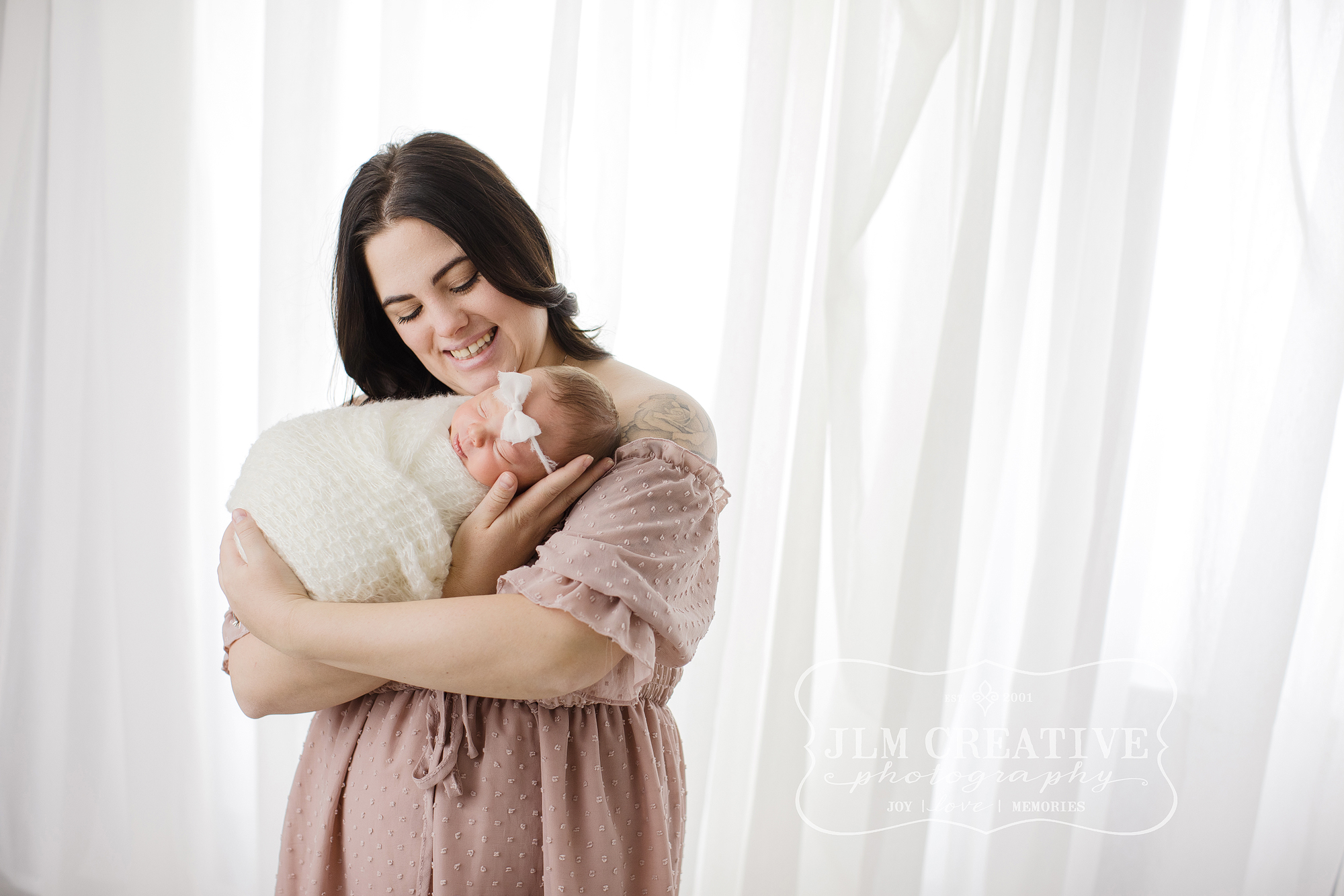 mom snuggles baby girl