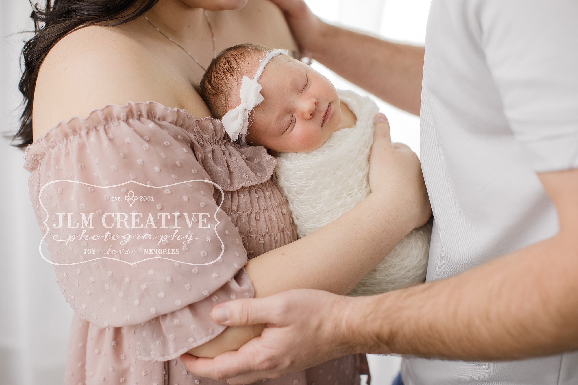 Family with new baby on white background